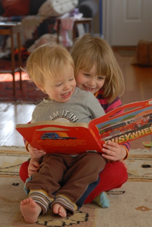 Siblings reading book