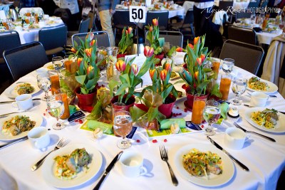 Luncheon table with tulip favors and fully plated food.